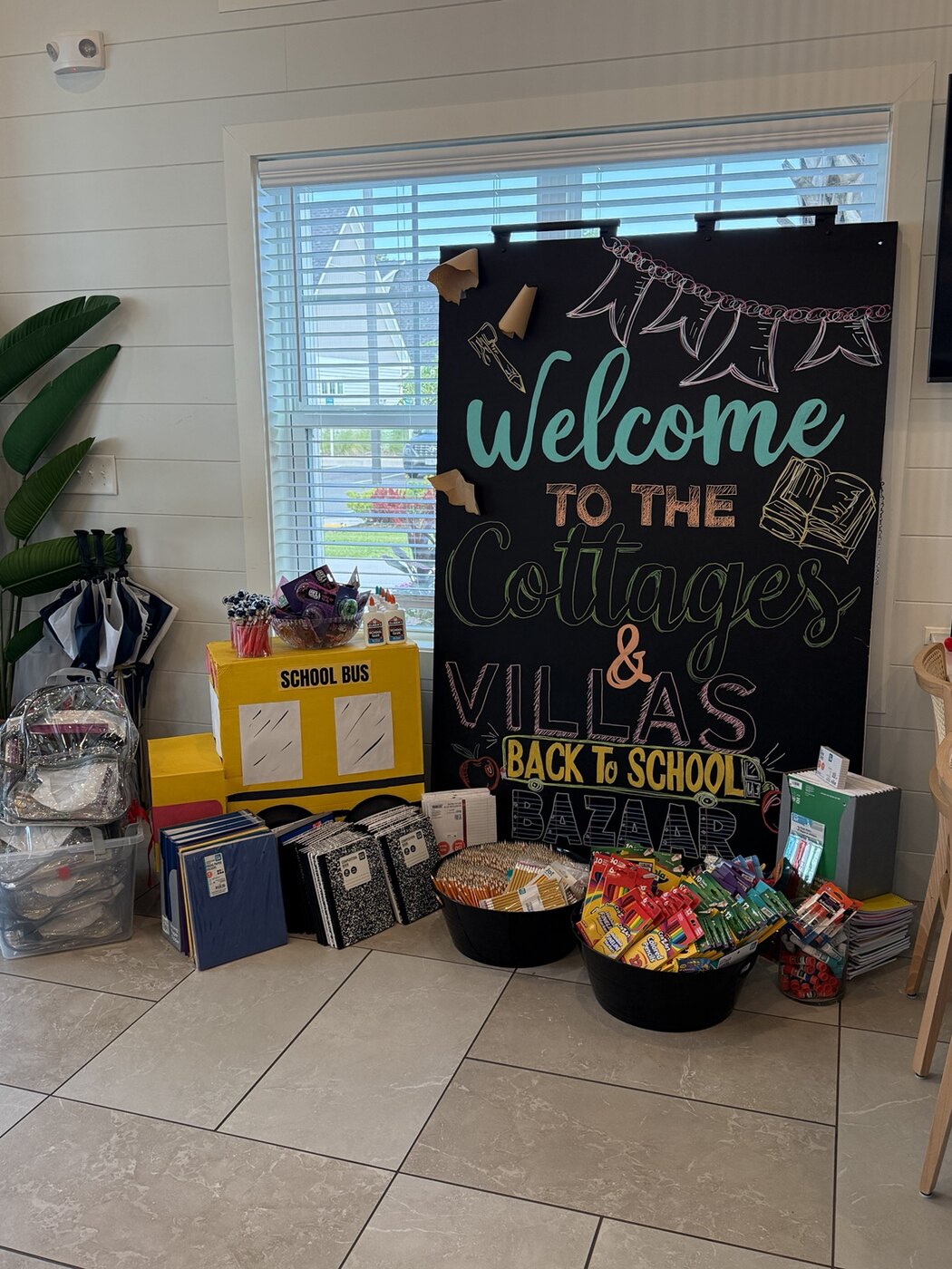 Back-to-School Bazaar welcome display surrounded by donated school supplies